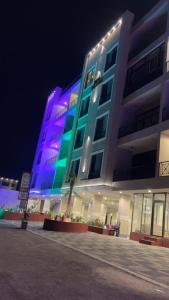 a large building with blue and green lights on it at استديو in Al Khobar