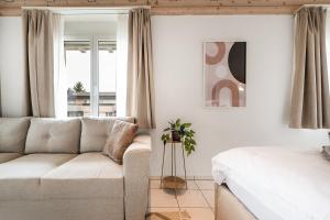 a living room with a couch and a bed at COZY 3 !Gratis Parken, Free Parking! in Weinfelden