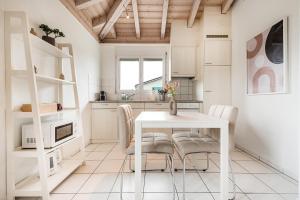 a white kitchen with a white table and chairs at COZY 3 !Gratis Parken, Free Parking! in Weinfelden