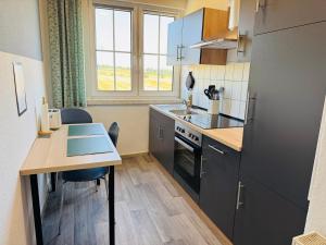 a small kitchen with a table and a stove at FeWo Einetal 1 im schönen Ostharz in Harzgerode