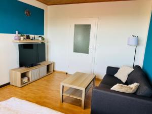 a living room with a couch and a table at FeWo Einetal 1 im schönen Ostharz in Harzgerode