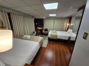 a hotel room with two beds and a lamp at Casa Hotel Lago Titicaca in Puno