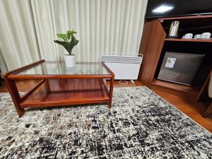 a coffee table with a potted plant on top of a rug at Casa Hotel Lago Titicaca in Puno +153 photos
