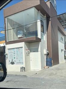 a building with a large window on the side of it at Departamentos De Cadereyta in Cadereyta Jiménez