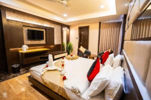 a bedroom with a large bed with red and white pillows at The Crystal Park in Kishangarh