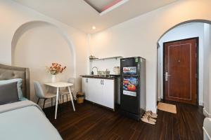 a room with a bed and a kitchen with a refrigerator at M Home Riverside in Ho Chi Minh City +62 photos