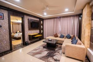 a living room with a couch and a tv at The Crystal Park in Kishangarh