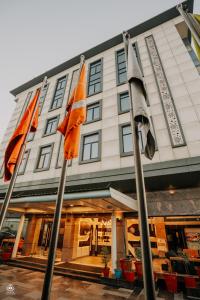 a hotel with three flags in front of it at The Crystal Park in Kishangarh +11 photos