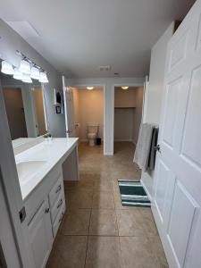 a bathroom with two sinks and a toilet in it at House in Hannibal in Hannibal +27 photos