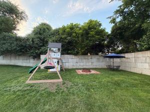 a playground with a slide and an umbrella in a yard at House in Hannibal in Hannibal