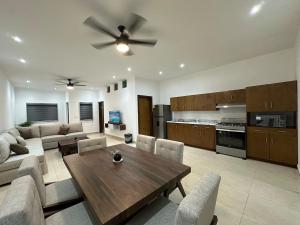 a living room with a wooden table and a ceiling fan at Cumbres Living in Saltillo