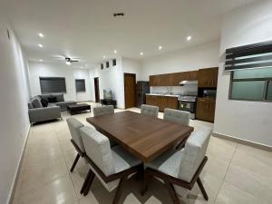 a kitchen and living room with a wooden table and chairs at Cumbres Living in Saltillo +19 photos