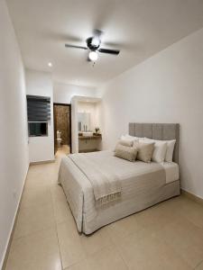 a bedroom with a large bed with a ceiling fan at Cumbres Living in Saltillo