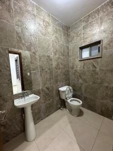 a bathroom with a toilet and a sink at Cumbres Living in Saltillo