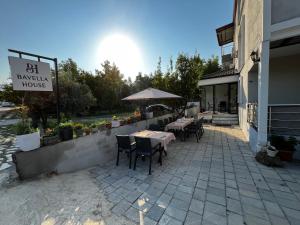 a restaurant with tables and chairs outside of a building at Bavella House in Pamukkale