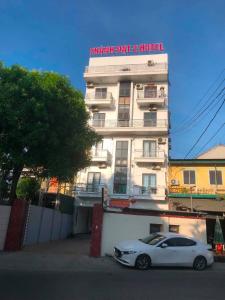 a white car parked in front of a building at Thanh Dat 2 Hotel in Vinh