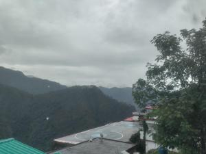 a view of a tennis court in the mountains at Inaya resort in Phata +1 photo