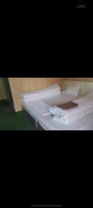 a close up of two beds with white sheets at Inaya resort in Phata
