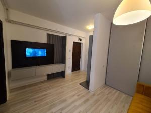 a living room with a flat screen tv on a wall at Bran' s in Constanţa
