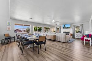 a dining room and living room with a table and chairs at Resort-Style 5BR Heated Pool Putting Green in Glendale