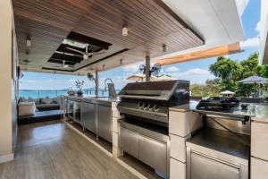 an open kitchen with a view of the ocean at Villa Skyfall Thailand Phuket in Panwa Beach