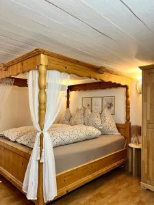 a bedroom with a wooden bed with a canopy at Umundumhütte in Katsch an der Mur