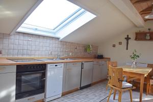 a kitchen with a skylight in the ceiling with a table at Ferienwohnung Wiedenhofer in Regenstauf