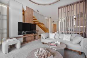 a living room with a couch and a tv at Balangan Residence in Payangan