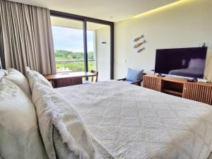 a bedroom with a large bed and a television at Escapada romántica- decoración sobre pedido in Nuevo Vallarta +26 photos