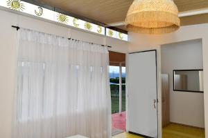 a room with a white curtain and a chandelier at HUAIRA Tatacoa in Villavieja