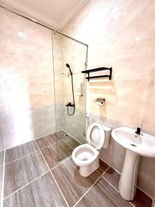 a bathroom with a shower and a toilet and a sink at Hotel Asia Express near Farmhouse Lembang in Lembang +60 photos