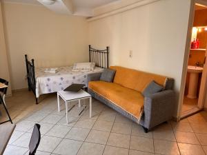 a living room with a couch and a table at M A Apartments in Chios