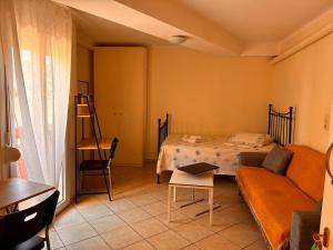 a living room with a couch and a bed at M A Apartments in Chios