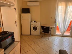 a kitchen with a washing machine and a washer at M A Apartments in Chios