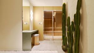 a bathroom with a shower and a cactus at Anook Hotel Busan Gwangalli in Busan
