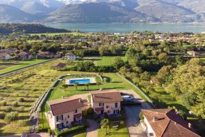 an aerial view of a house with a lake and mountains at Iris in Colico