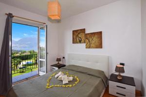 a bedroom with a bed and a large window at Iris in Colico
