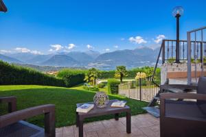 a patio with a table and a view of mountains at Iris in Colico +34 photos