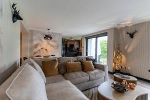 a living room with a couch and a table at Gleneagles Village Penthouse in Tullibardine Station