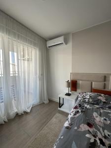 a white bedroom with a bed and a window at Aurum Apartmanı in Vodice +17 photos