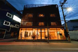 a building with windows and a fire hydrant in front of it at Stay C Hotel in Ban Samet