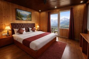 a bedroom with a large bed and a large window at Hotel The Nature Heaven, Mussoorie - Affordable Luxury Stay in Mussoorie with Mountain View in Mussoorie