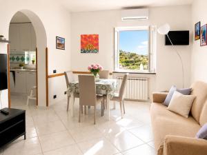 a living room with a table and chairs and a couch at Appartamento Casa di Sole Ischia in Ischia Town