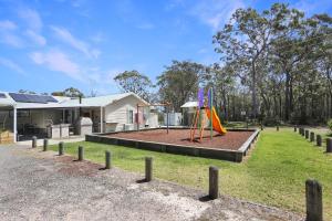 a park with a playground in front of a house at Perfect Seclusion Top Level Only in North Arms Cove
