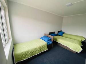 a room with two beds in a room at Family nest in Kochkorka