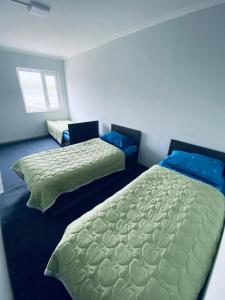 a bedroom with two beds and a window at Family nest in Kochkorka +9 photos