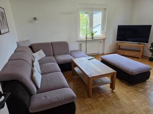 a living room with a couch and a coffee table at Seehaus Brigitte in Owingen