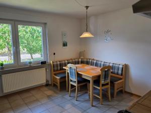 a dining room with a table and chairs at Seehaus Brigitte in Owingen