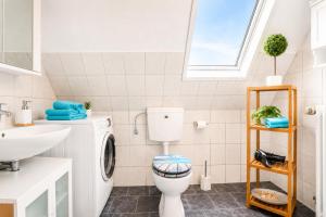 a bathroom with a toilet and a sink at Dünenlounge Dornumersiel in Dornum +33 photos