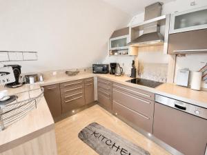 a kitchen with wooden counters and stainless steel appliances at Seehund in Neuharlingersiel
